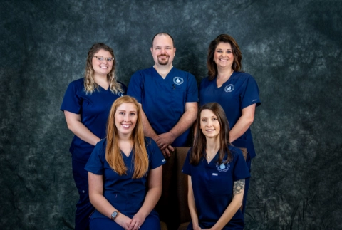 A professional group portrait of the medical and administrative staff at The Vein Company’s Abingdon location, posing together in a clinical office setting.