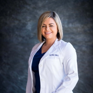 A professional headshot of Ashley Ball, a wound care specialist at The Vein Company, smiling in a clinical office setting.