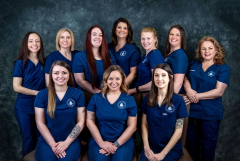 A professional group portrait of the medical and administrative team at The Vein Company’s Johnson City location, posing together inside a modern clinical office.