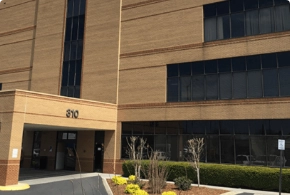 The exterior entrance of The Vein Company clinic in Johnson City, featuring a modern brick building with professional signage.