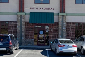 The exterior entrance of The Vein Company clinic in Kingsport, featuring a modern brick building with professional signage and large windows.