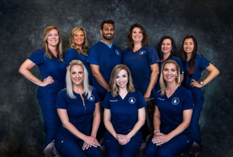 A professional group portrait of the medical and administrative staff at The Vein Company’s Sevierville and Knoxville locations, posing together in a clinical office setting.